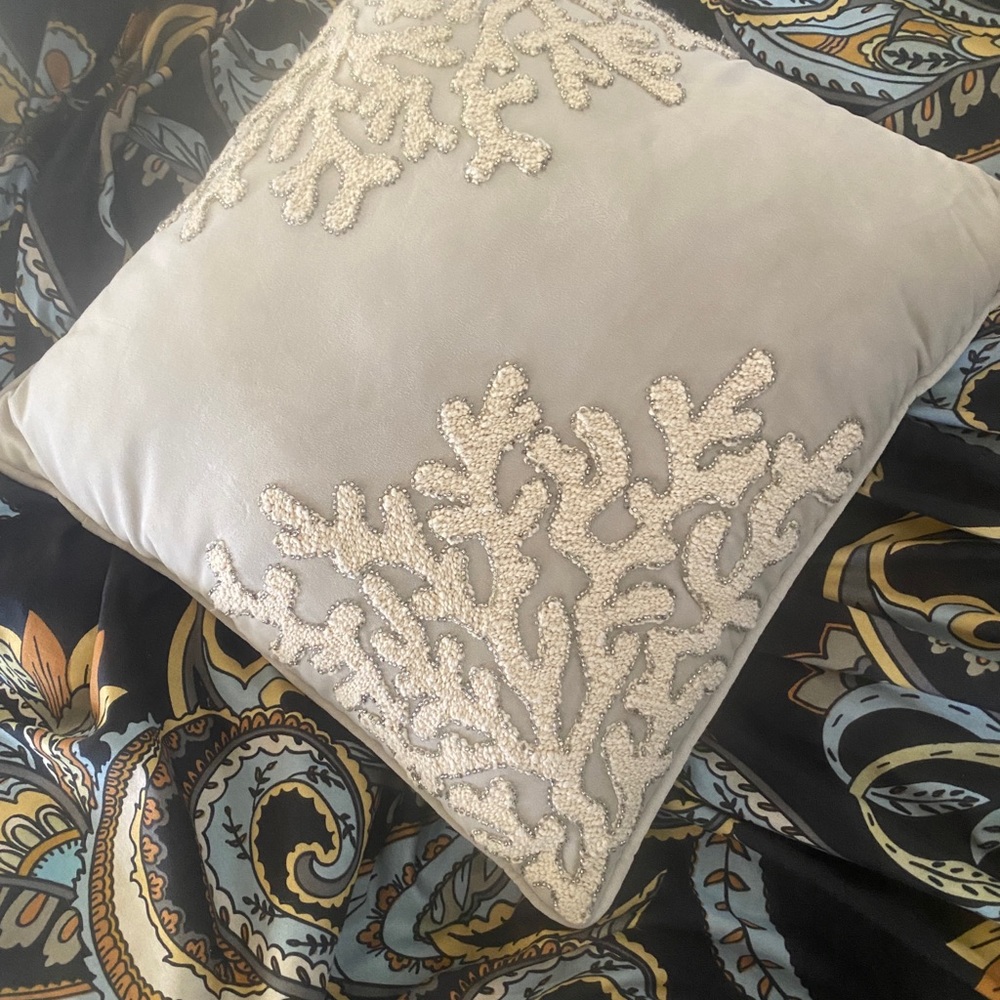 Soft dove grey pillow with white coral outlined with silver seed beads.